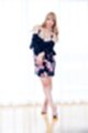 Dress shrugged from her shoulders wearing high heels